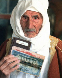 A Palestinian refugee in Lebanon holds his passport issued from Palestine under the British Mandate
