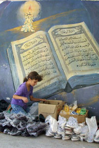 A Palestinian girl sells shoes